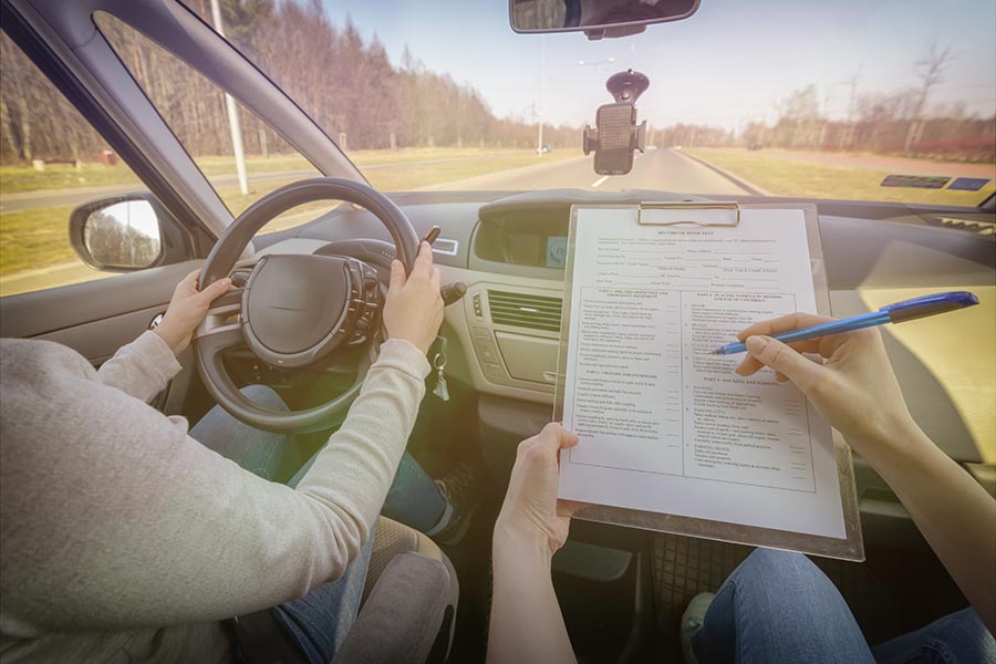 Specialized Business Insurance - Driving Instructor Giving Notes to a Student Driver